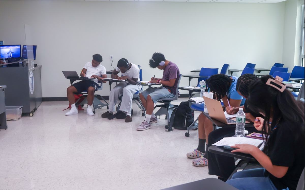 Two scholars practicing their pitches with feedback